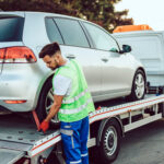 Handsome middle age man working in towing service on the road. R