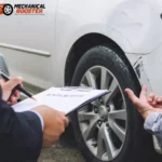 Insurance agent inspecting car damage and filling out an insurance claim report after a minor car accident.
